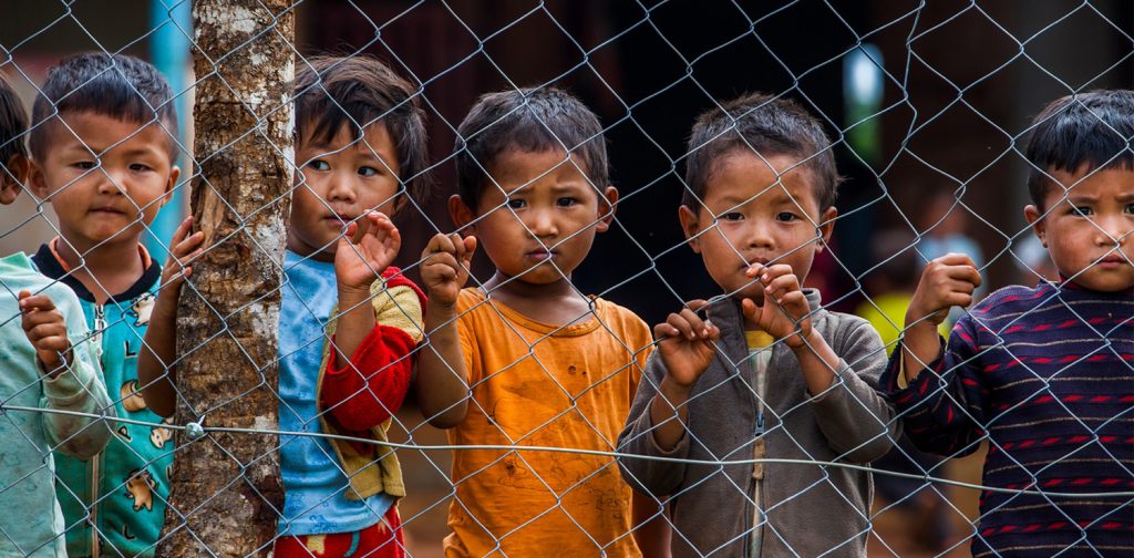 A photo by UNICEF of Myanmar children standing firmly, commemorating 70 years delivering for children - Humanitatian Needs Overview Myanmar