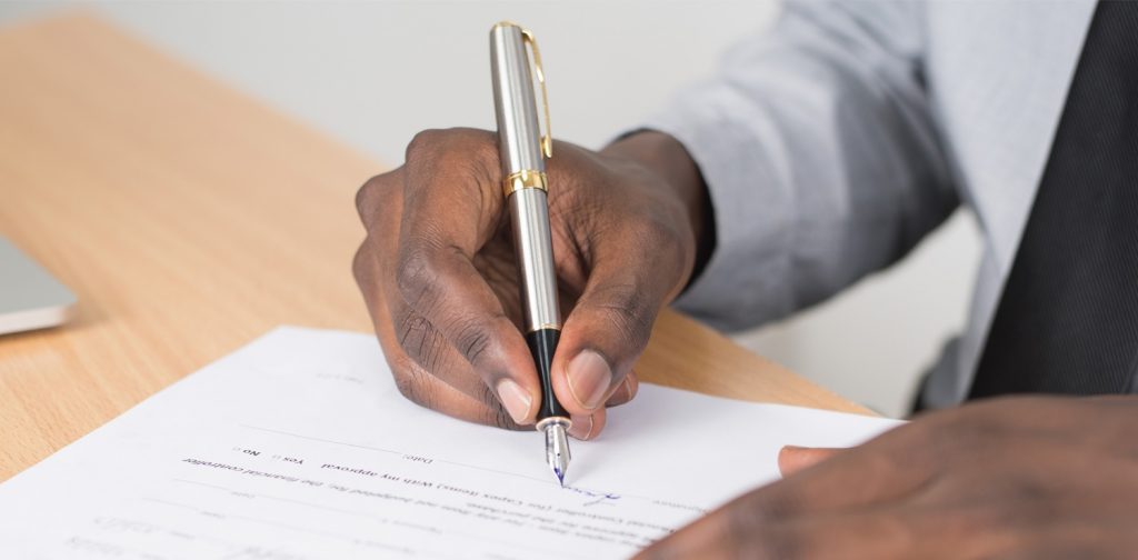 a man signing a document