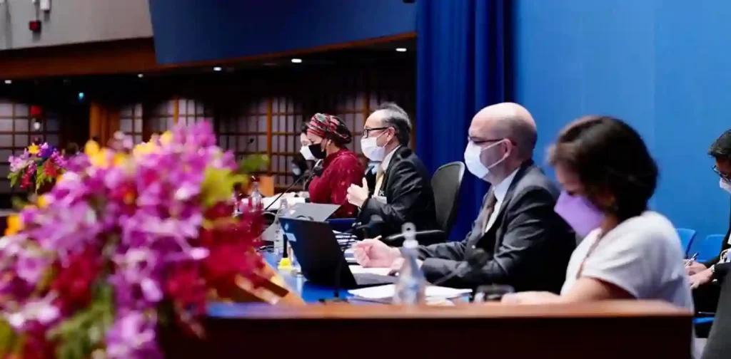 a side view of two men and two women sitting behind their desks at the ninth asia-pacific forum on sustainable development in Bangkok