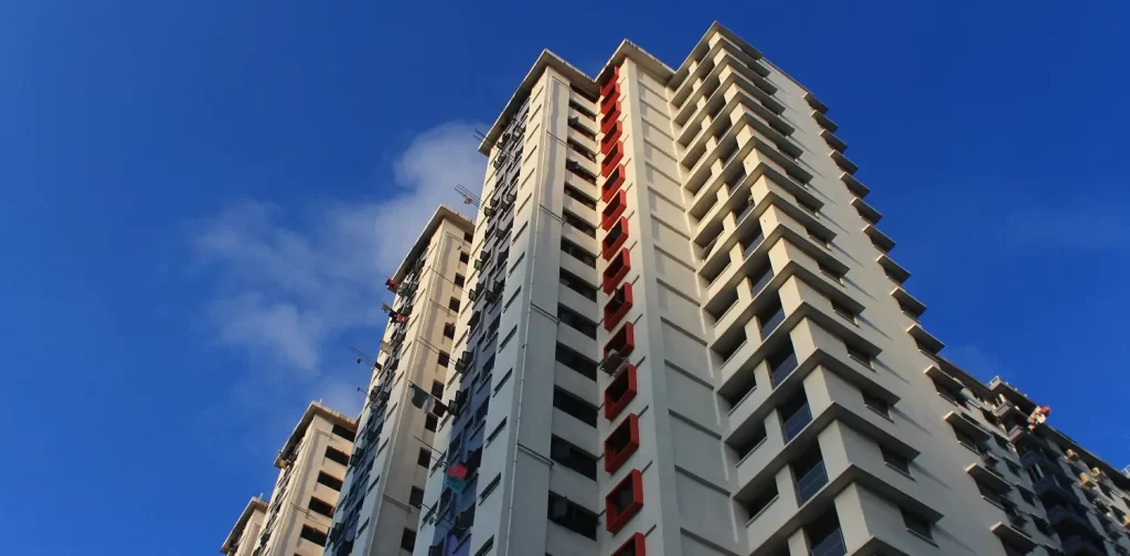 high stories housing building taken from low angle with blue sky background