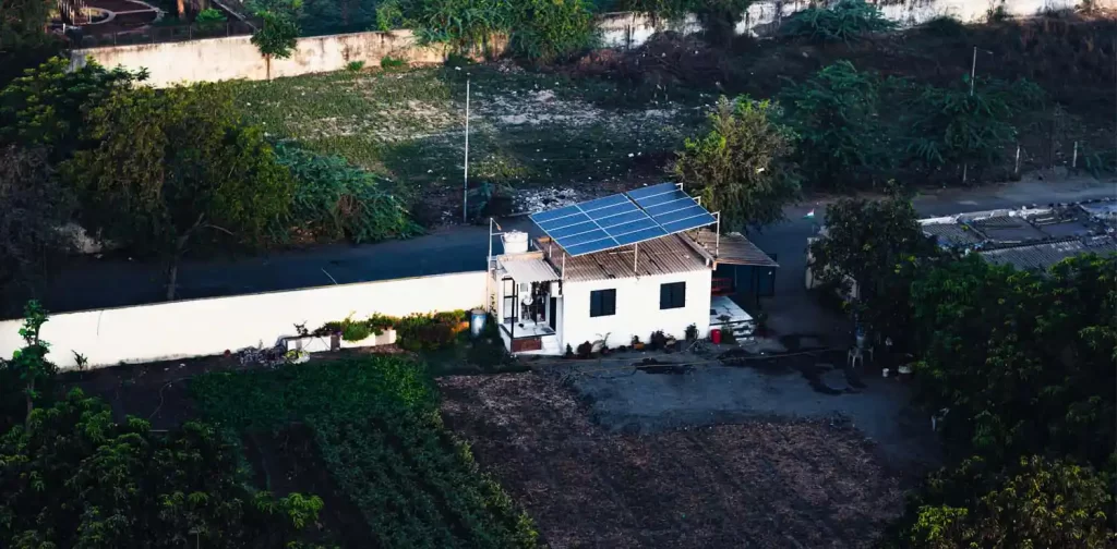 a small solar panel unit on the roof of a small building