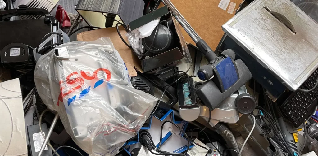 pile of electronic waste such as cables, keyboards, and other electrical appliances