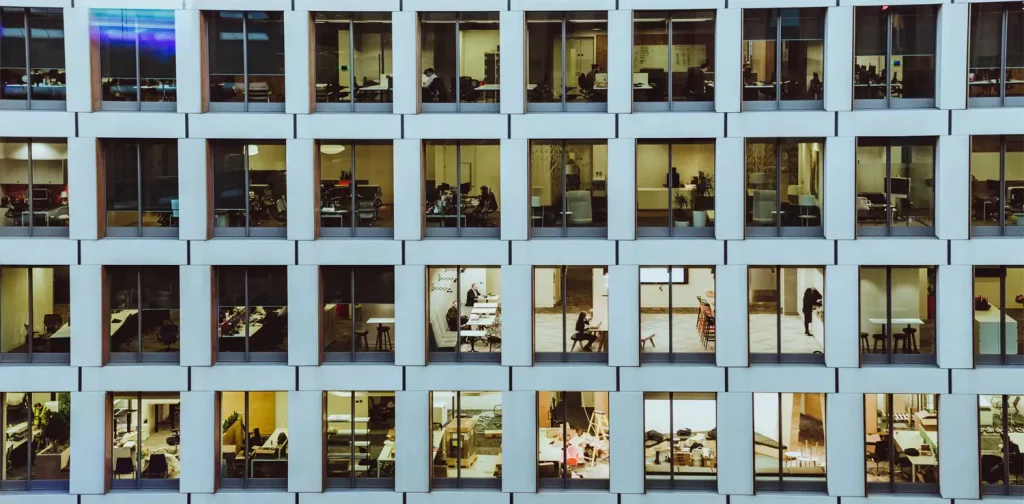 people inside a high-rise building viewed through the windows