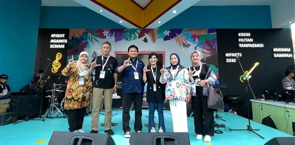 six people standing at java jazz a stage, a banner that says “KLHK” is stationed above them