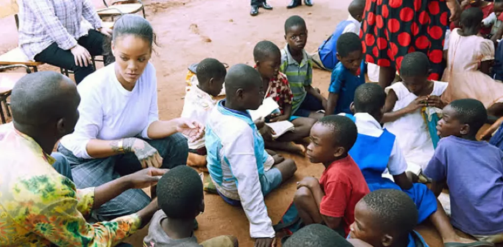 Rihanna sitting down with children