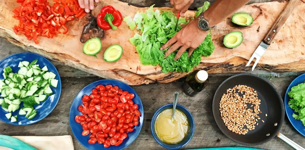 overhead view of hands slicing vegetables