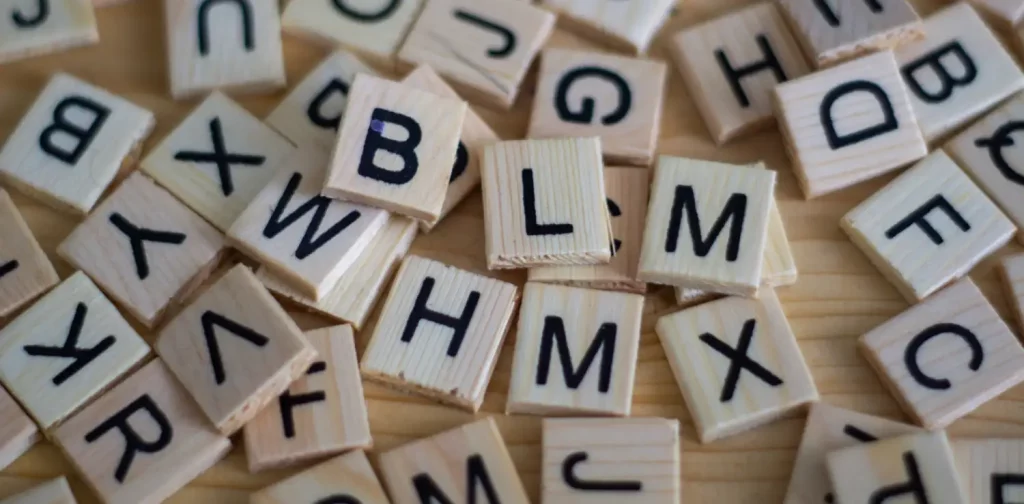 scattered alphabet letters in little squares similar to scrabble