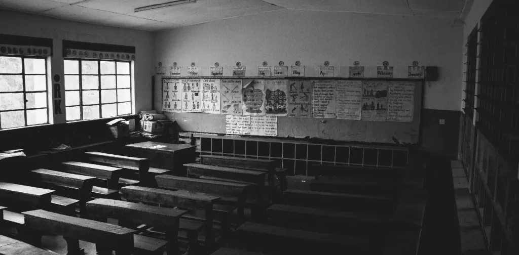 greyscale photo of an empty class room